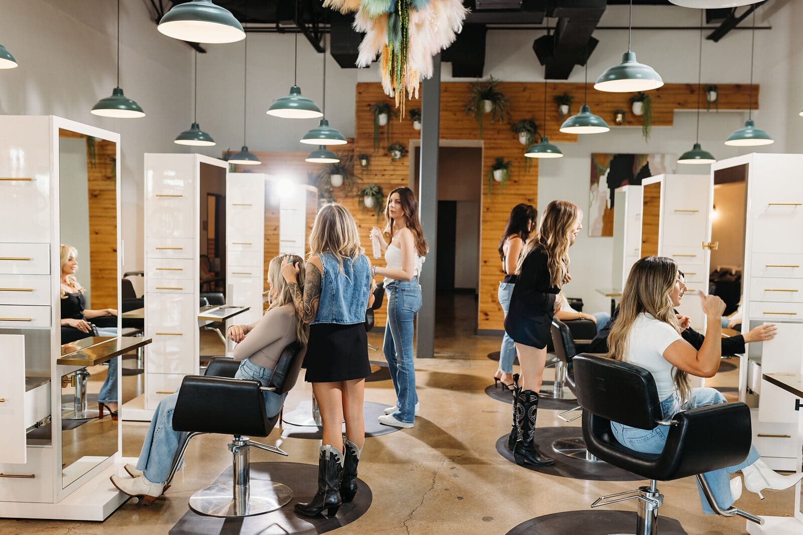 Several bex+Co.® members and clients on the open salon floor, mid-conversation