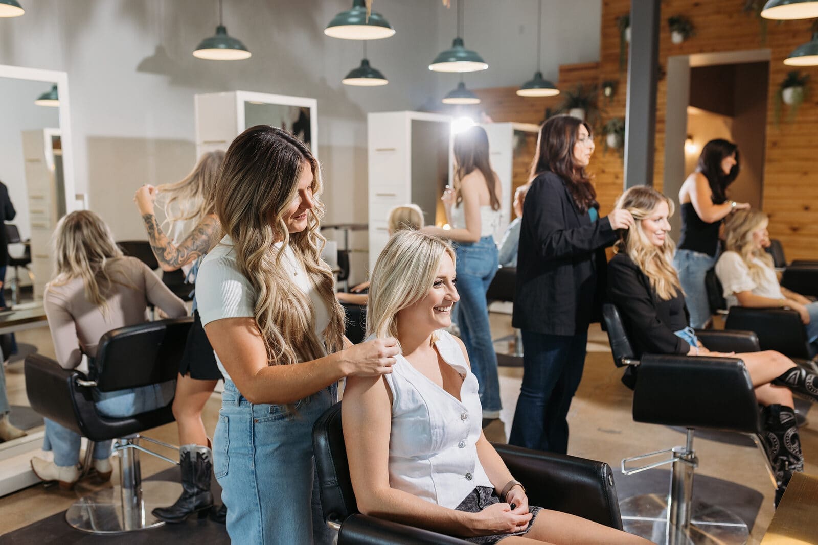 A bex+Co.® stylist working with a client on the open salon floor